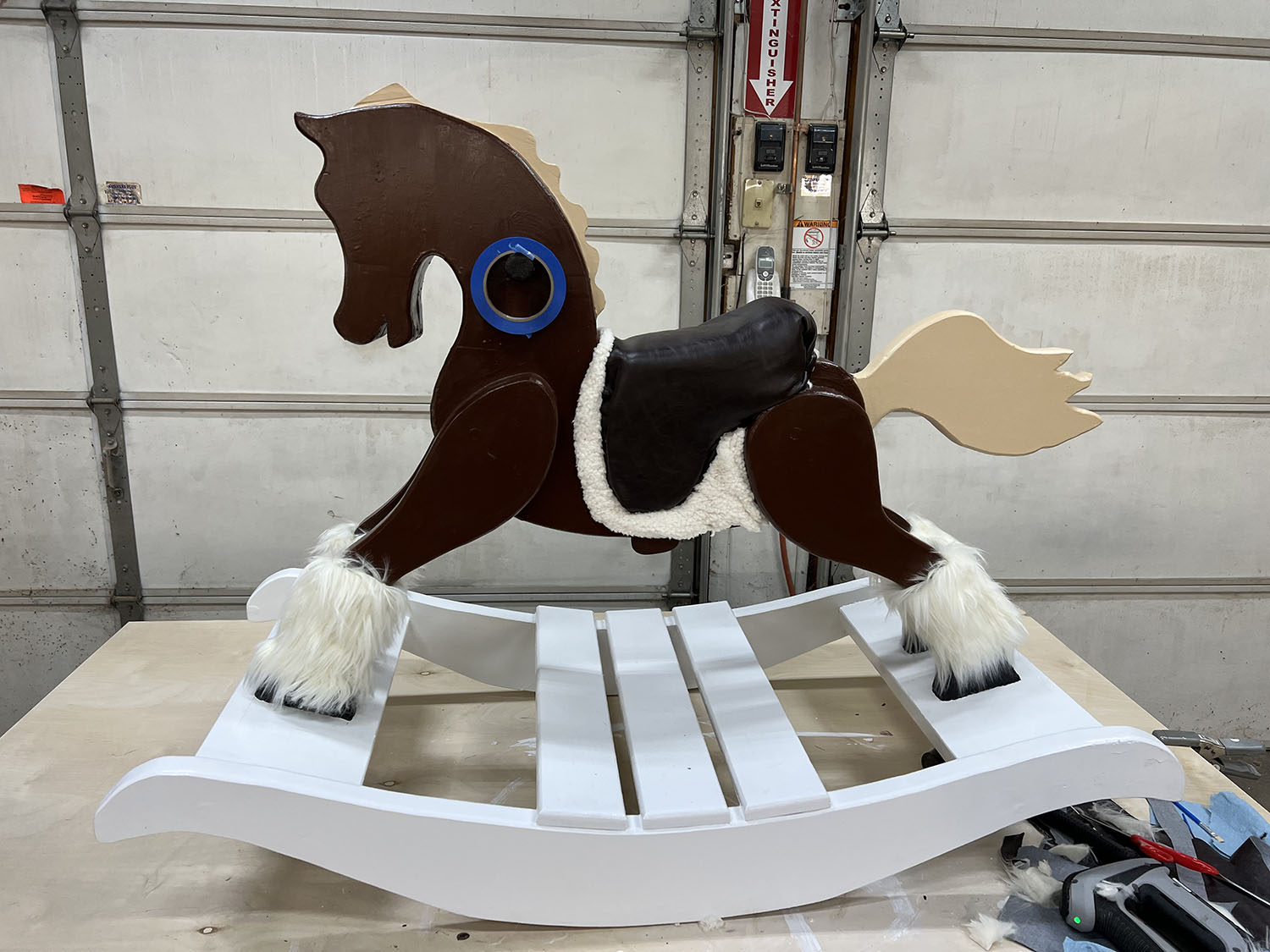 Wooden horse with fur and saddle